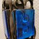 Wall lamps made of black cast iron and handmade thick pressed blue glass
