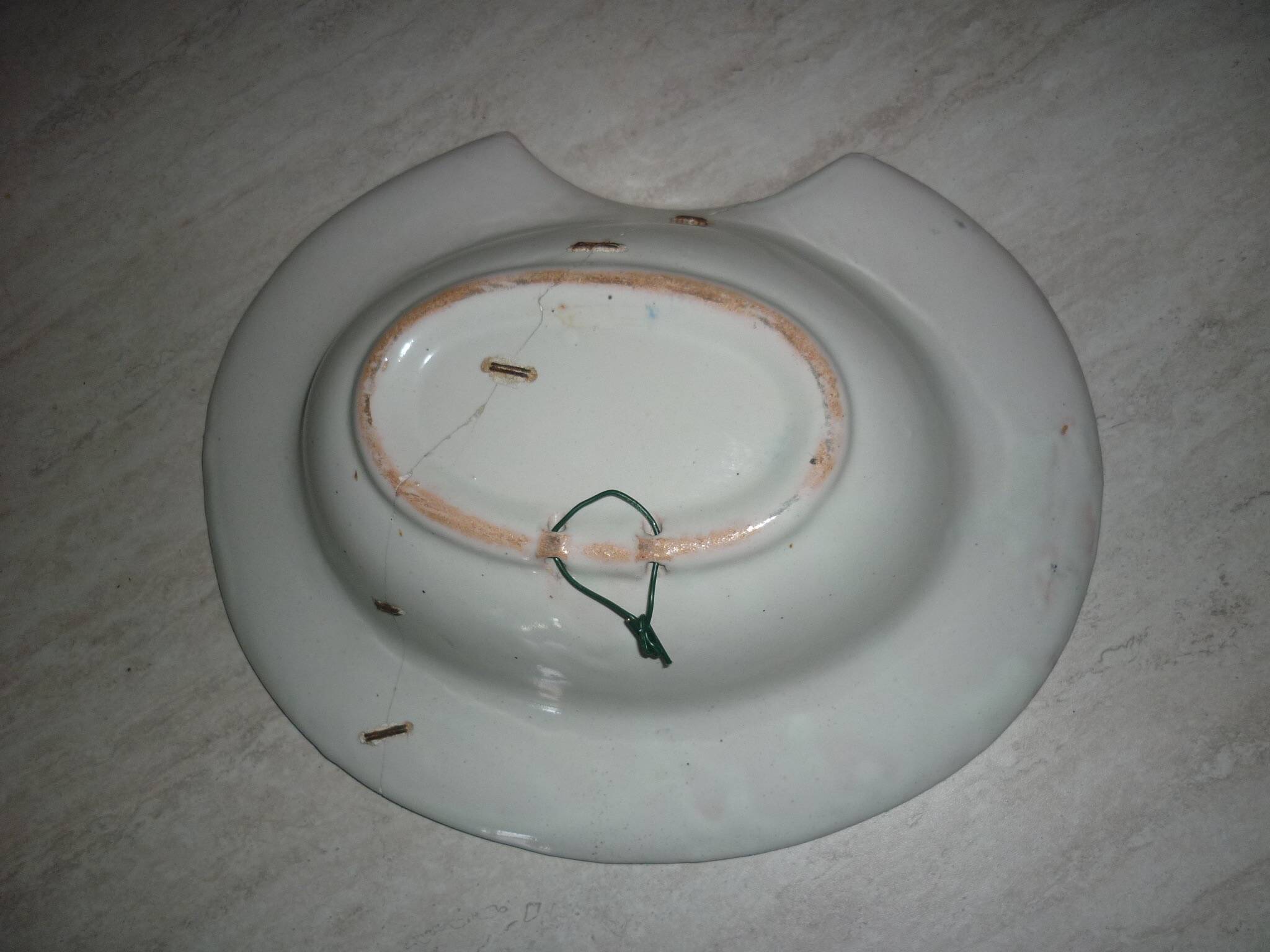 Old beard dish repair with staples