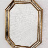 Octagonal mirror in Venetian style with gold-rimmed parecloses
