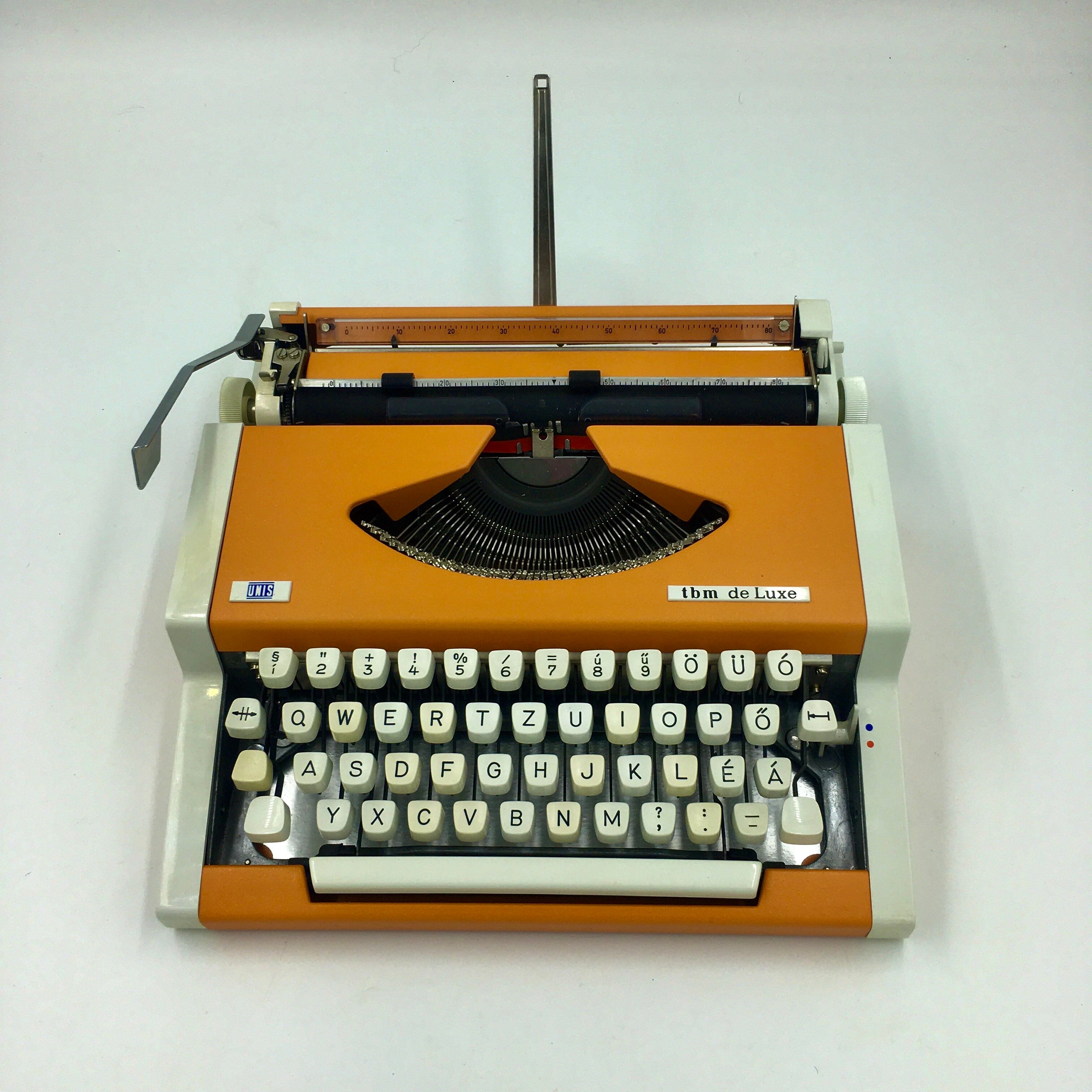 WE typewriter orange