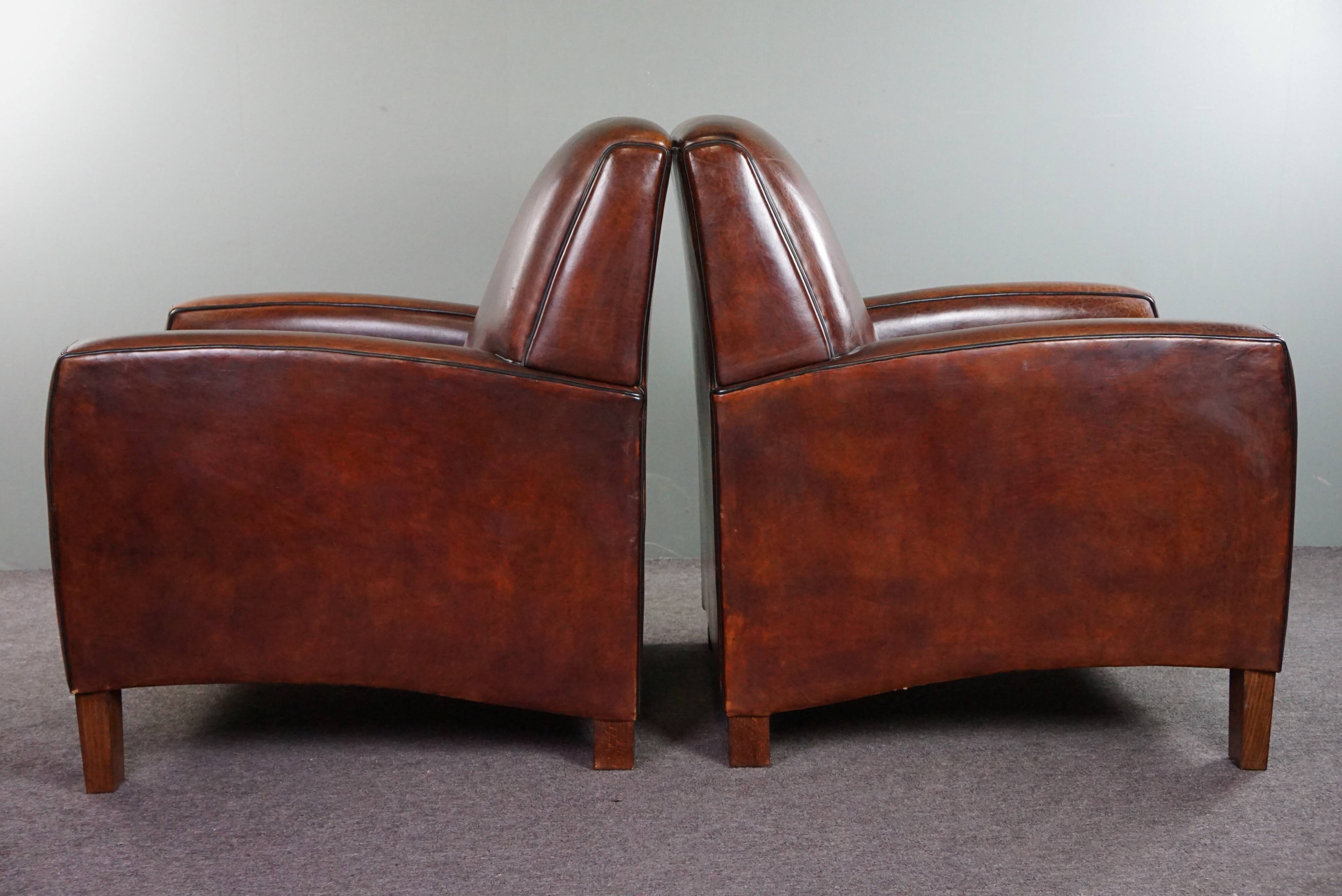 A very beautiful set of 2 Art Deco design armchairs in sheep leather