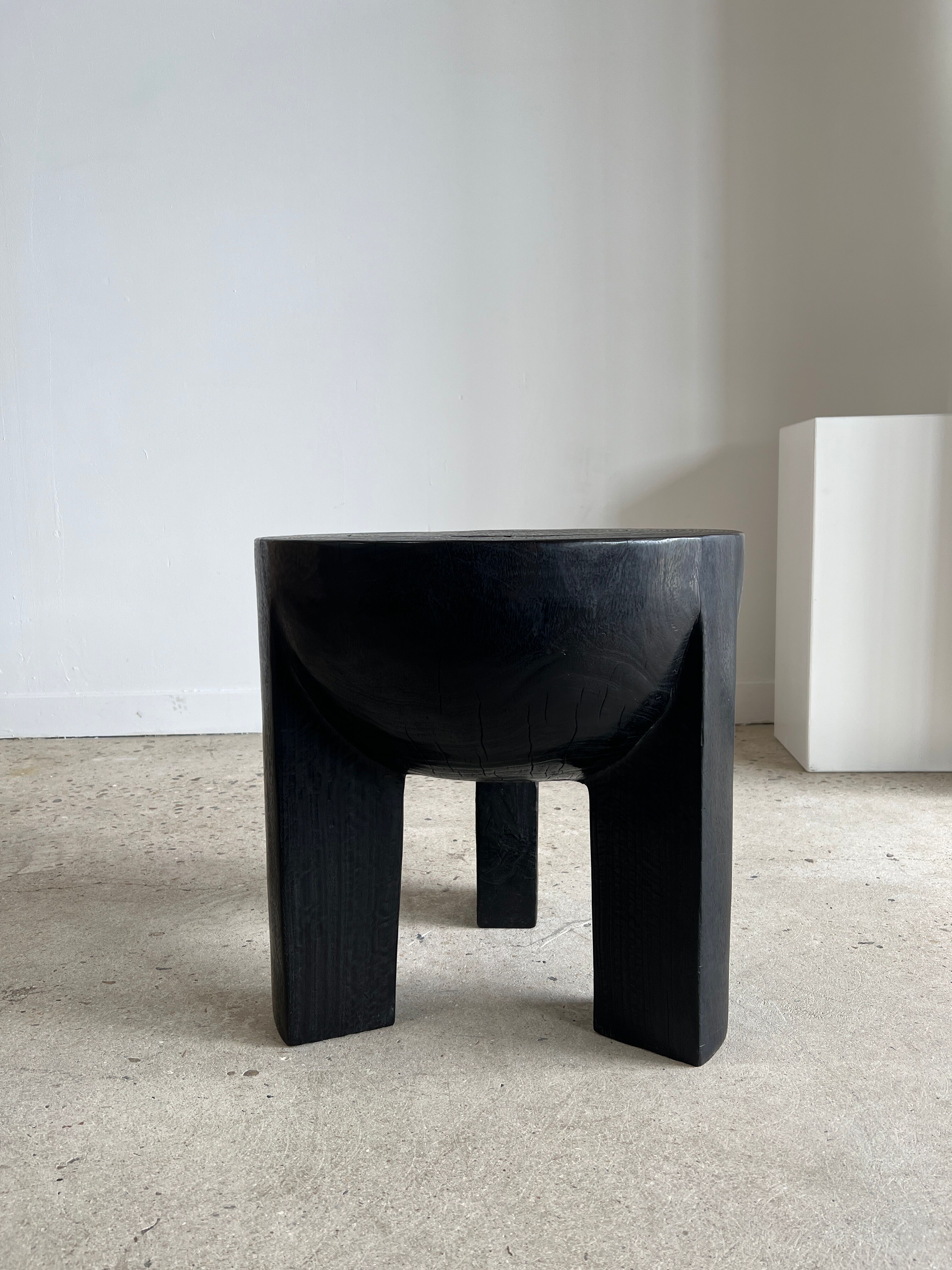 Black mango wood tripod side table with a semi-spherical top, height: 45 cm, diameter: 44 cm.