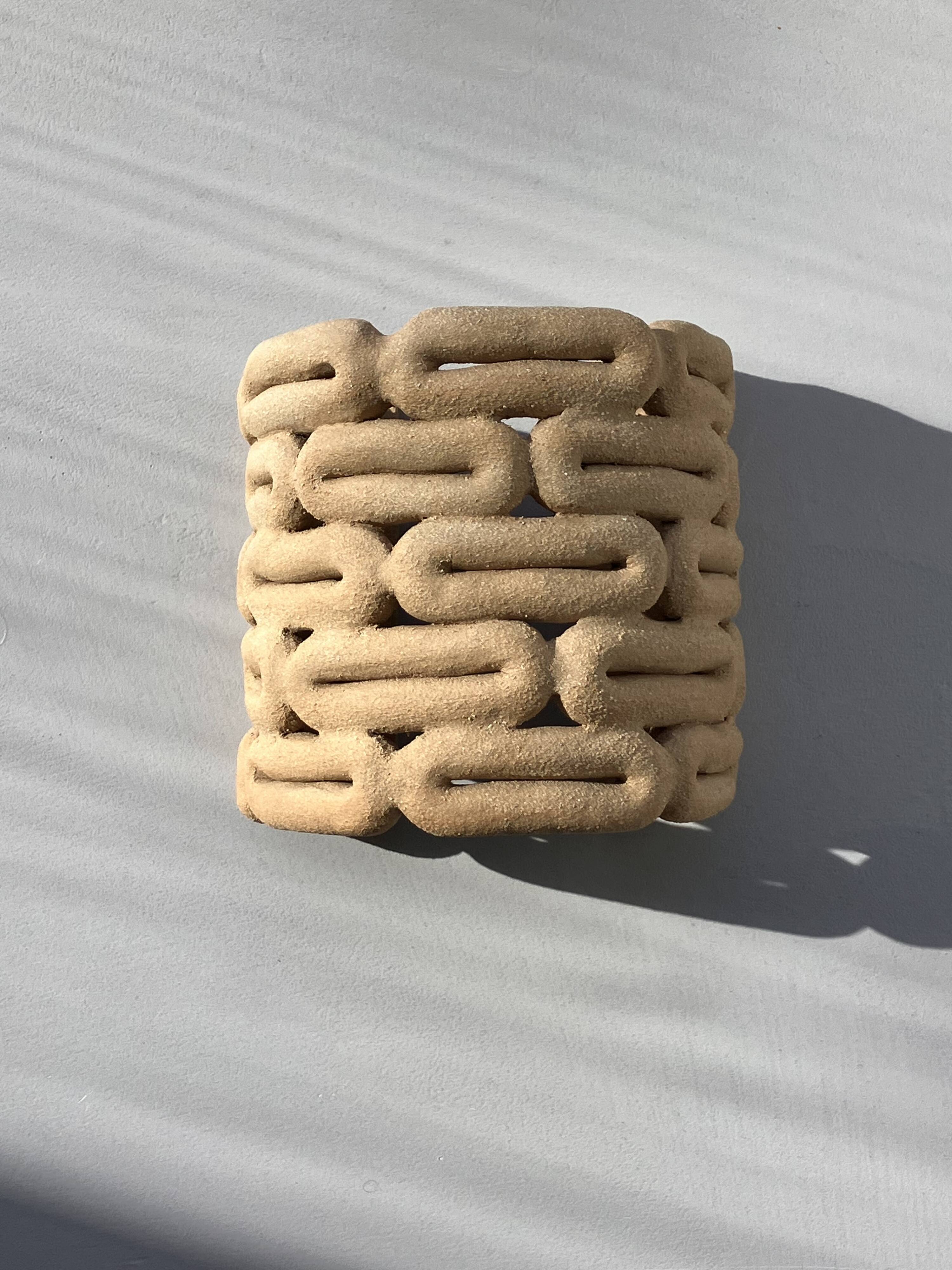 Handcrafted ceramic wall light in raw stoneware inspired by Mid Century design.