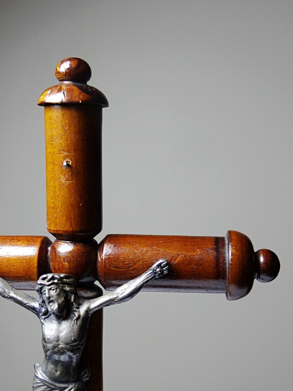 Antique wooden altar crucifix with a turned design and silver-plated Christ.