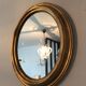 Old oval mirror in gilded wood