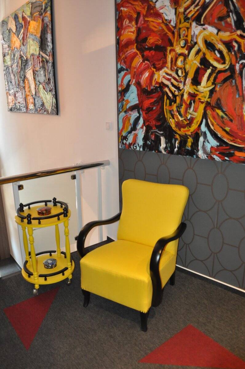 Art Deco armchair in yellow and black, made of painted wood and cotton, high back, 1920s.