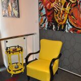 Art Deco armchair in yellow and black, made of painted wood and cotton, high back, 1920s.