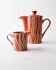 Vintage tea or coffee service in 1970s ceramic, teapot with lid and milk jug, rust orange with retro striped pattern, mid-century decoration, gift idea.