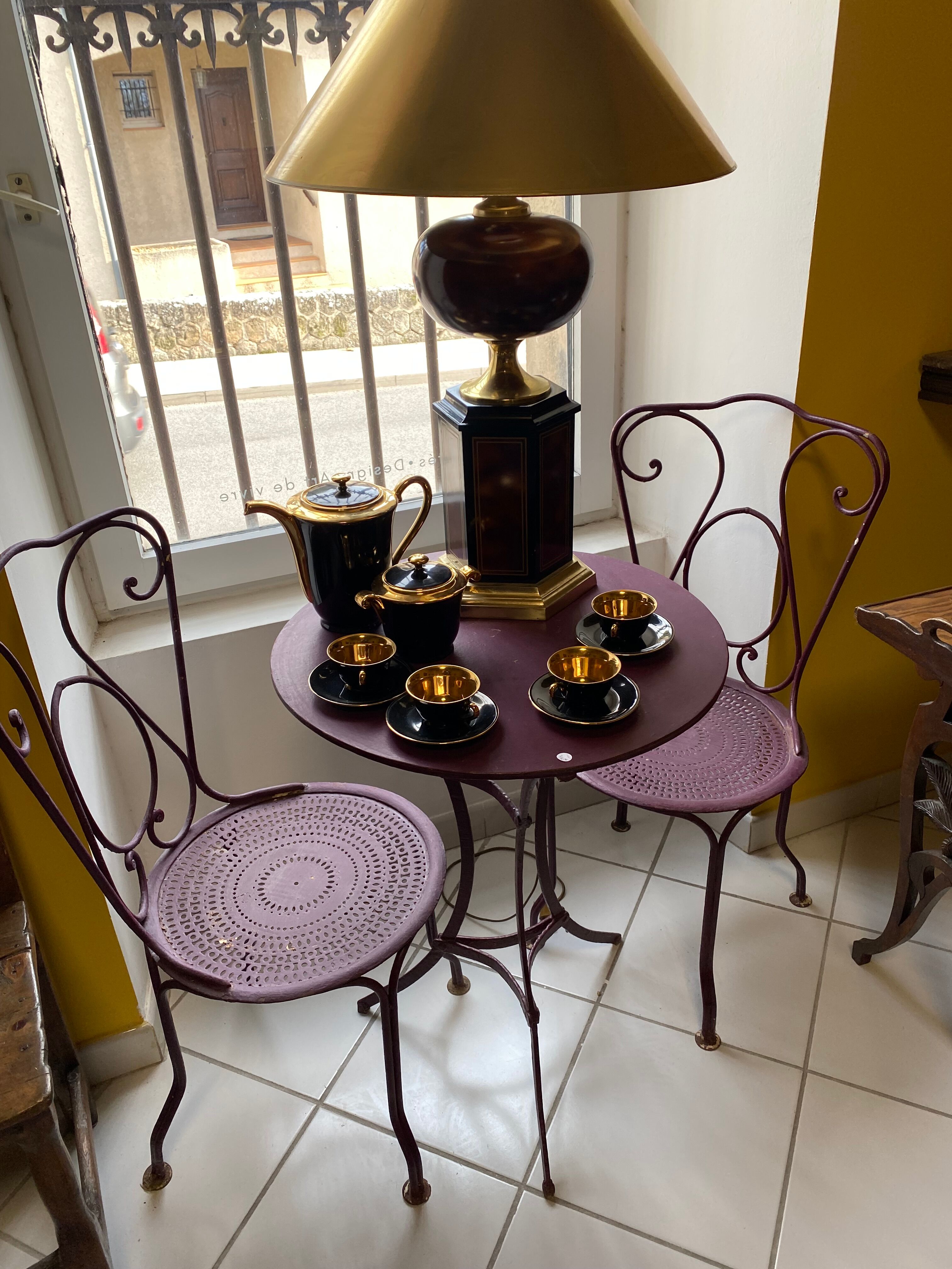 Set of two chairs and wrought iron pedestal table