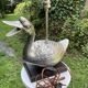 Old vintage lamp representing a duck in silver metal with wooden base