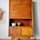 Vintage 1950s wooden secretary with tapered legs and mint interior.