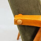 Mid-century modern design armchair in olive green corduroy.