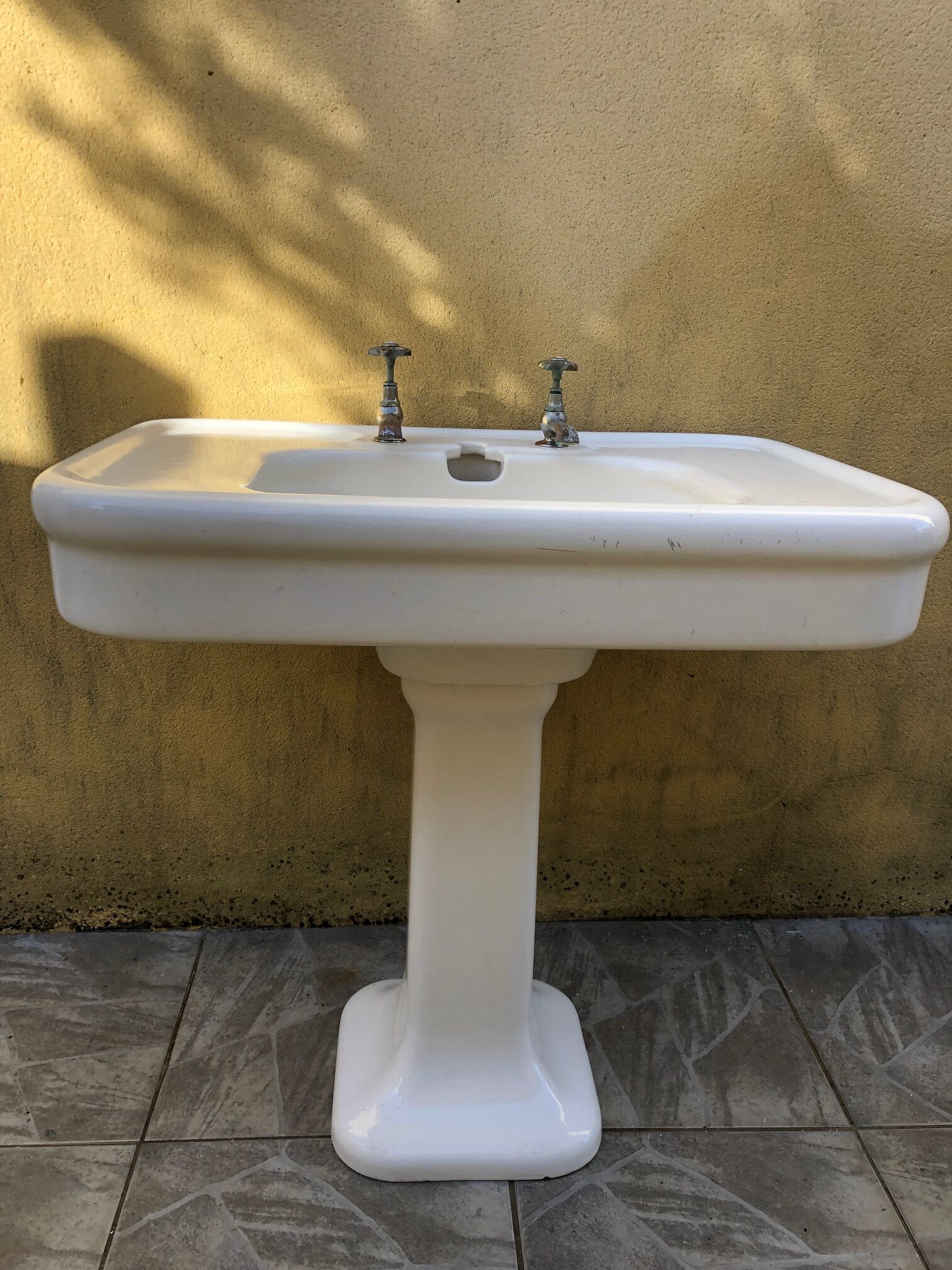 Antique washbasin on ceramic column