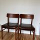 Two leather and Scandinavian teak chairs.