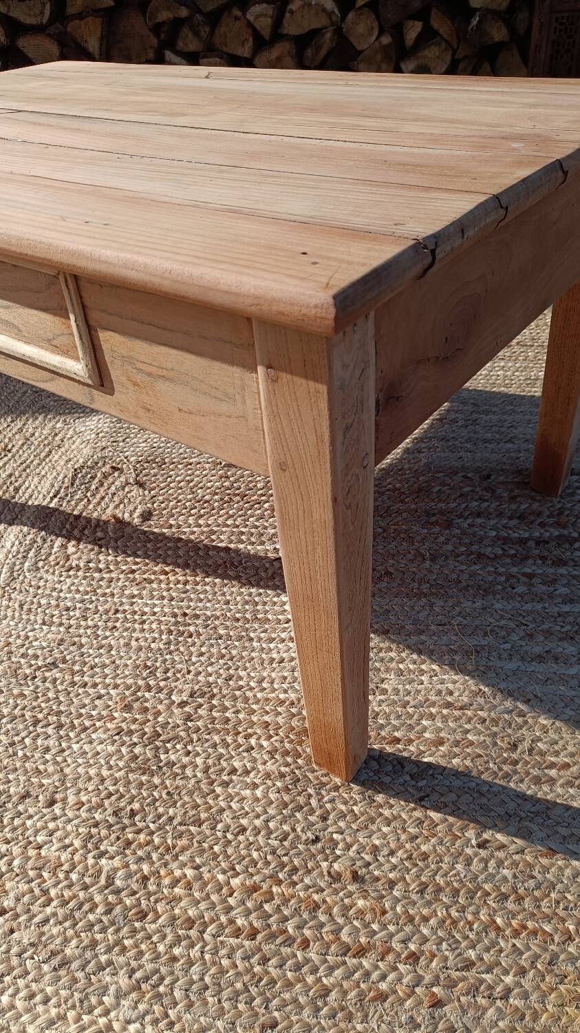 Low farmhouse table in raw wood