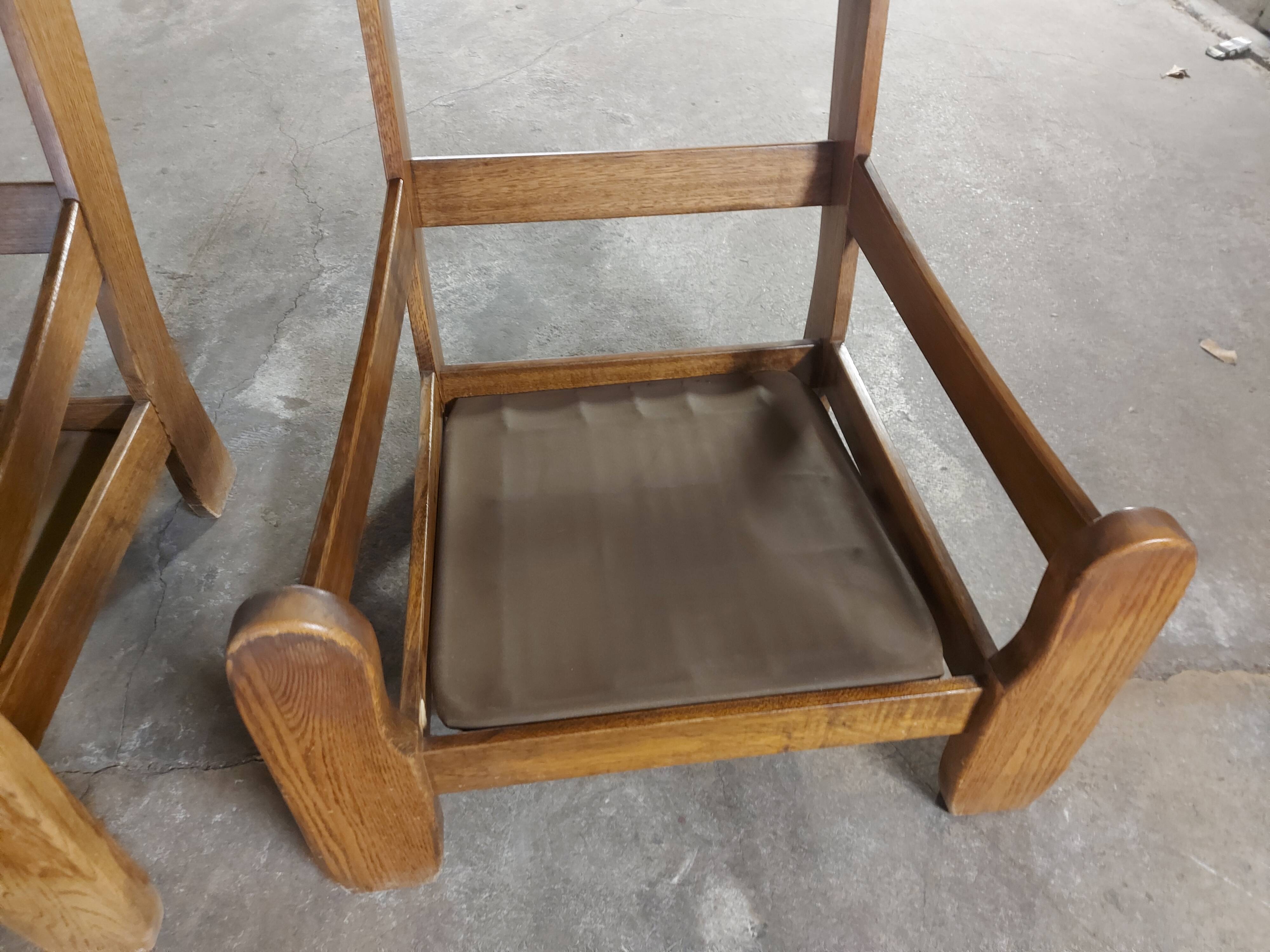 Armchairs in leather and vintage wood 70's