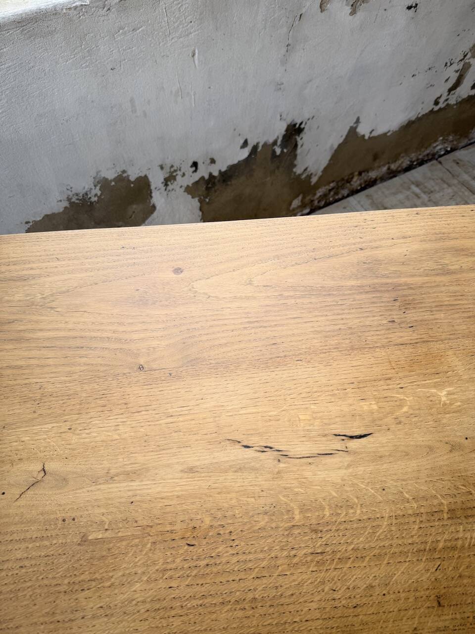 Oak farmhouse table with turned black legs.