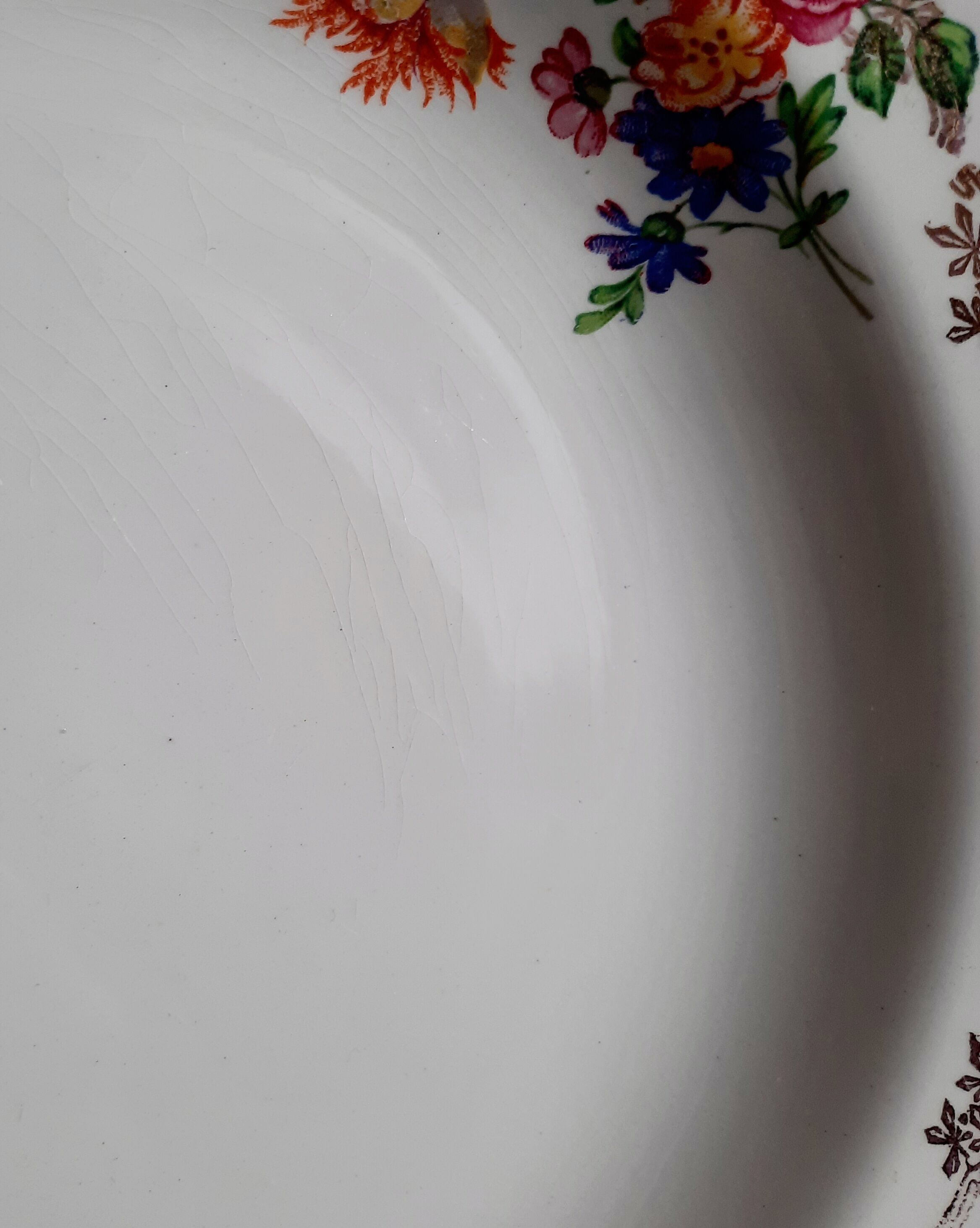 Old hollow plates mismatched in earthenware with gilded edges