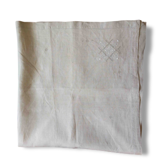 Embroidered string of white linen tablecloth