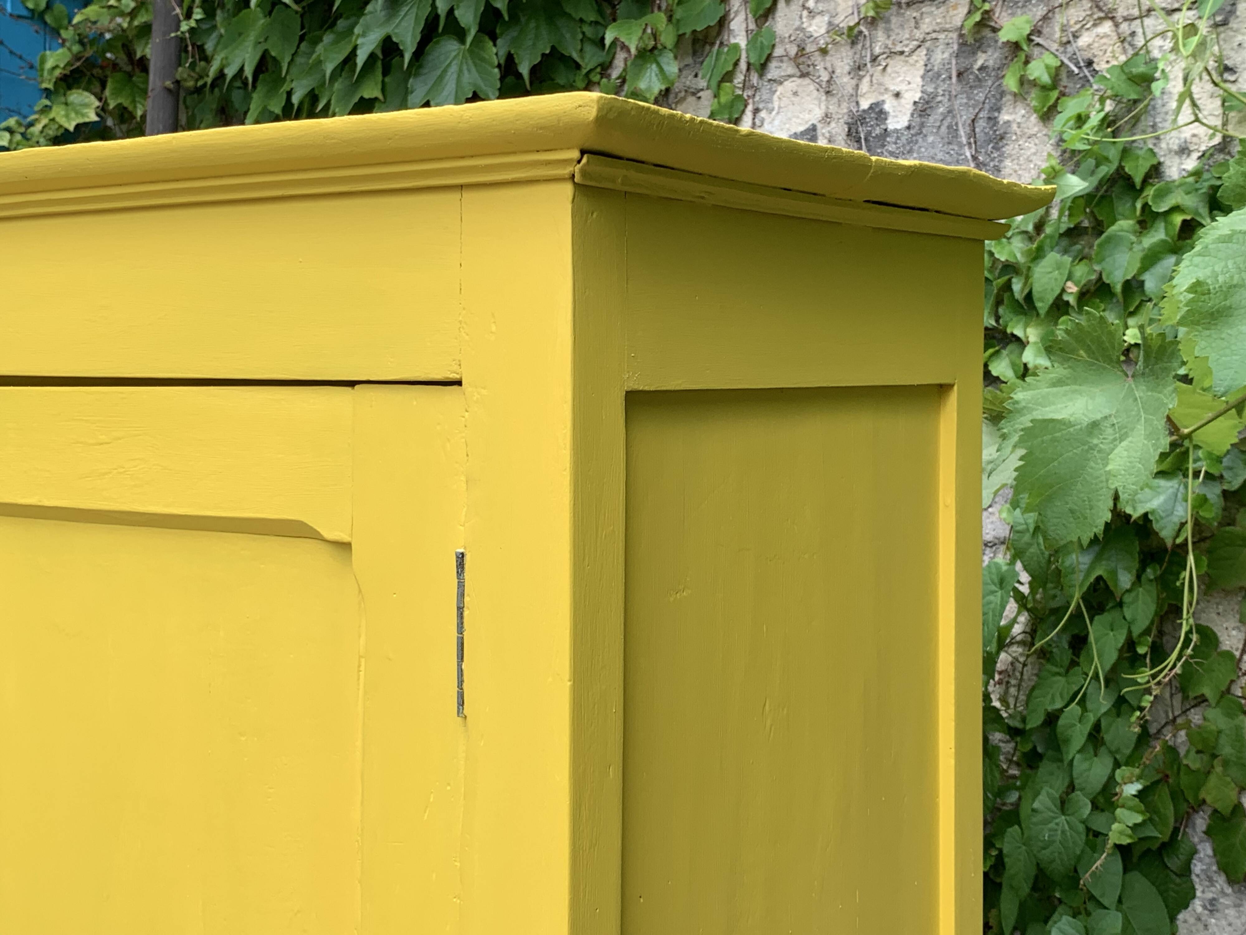 Antique powder yellow Parisian bonnetière wardrobe.