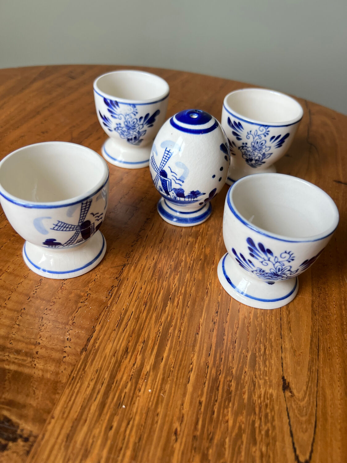 Set of 4 vintage egg cups and salt shaker in blue Delft pottery.