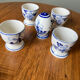 Set of 4 vintage egg cups and salt shaker in blue Delft pottery.