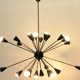 Sputnik 24 arms in black lacquered metal and brass chandelier