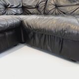 Vintage corner sofa composed of 3 modules in black leather with integrated bed.
