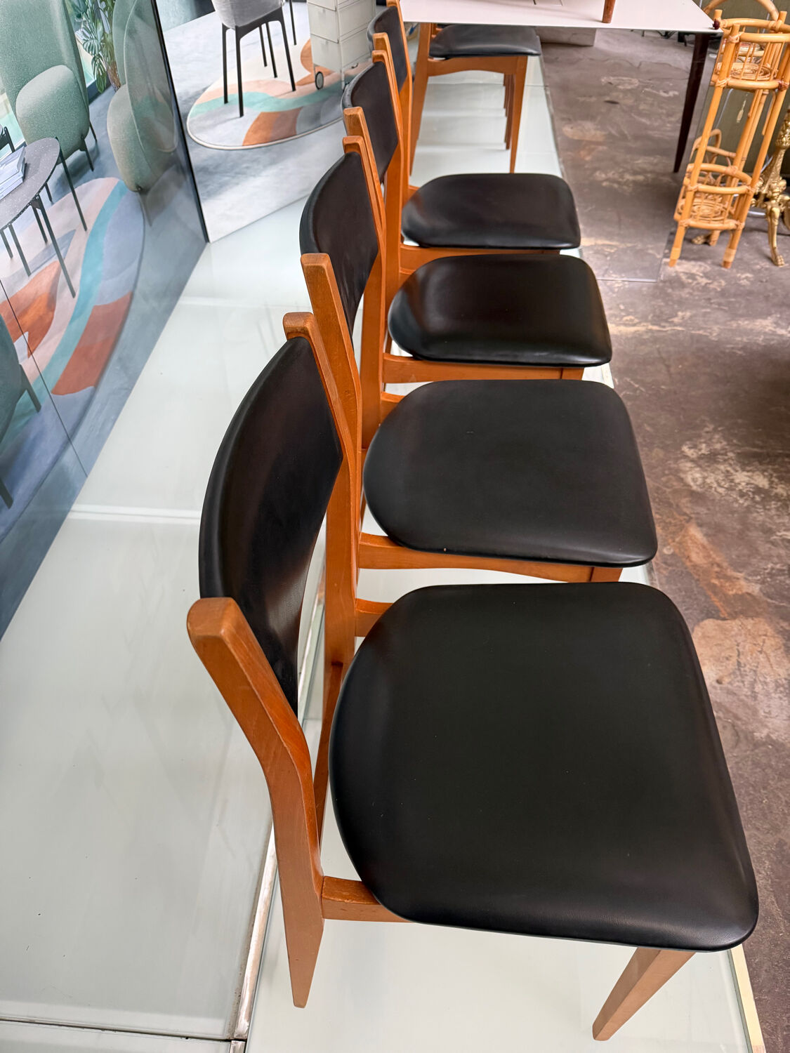4 Scandinavian chairs in teak and black faux leather.