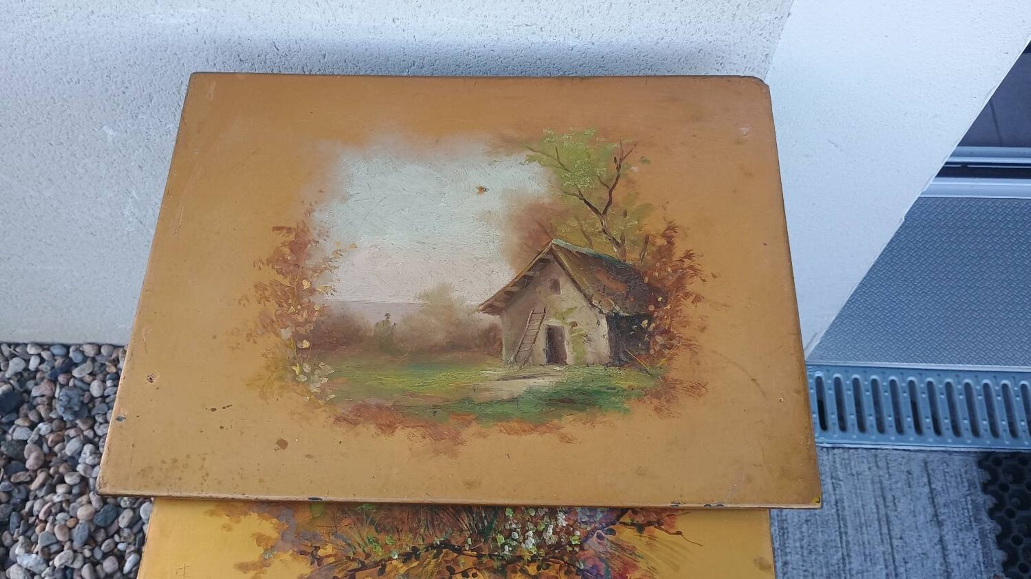 Sets of three nesting tables with painted landscape decorations in poplar.