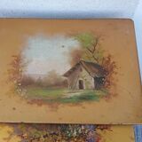 Sets of three nesting tables with painted landscape decorations in poplar.