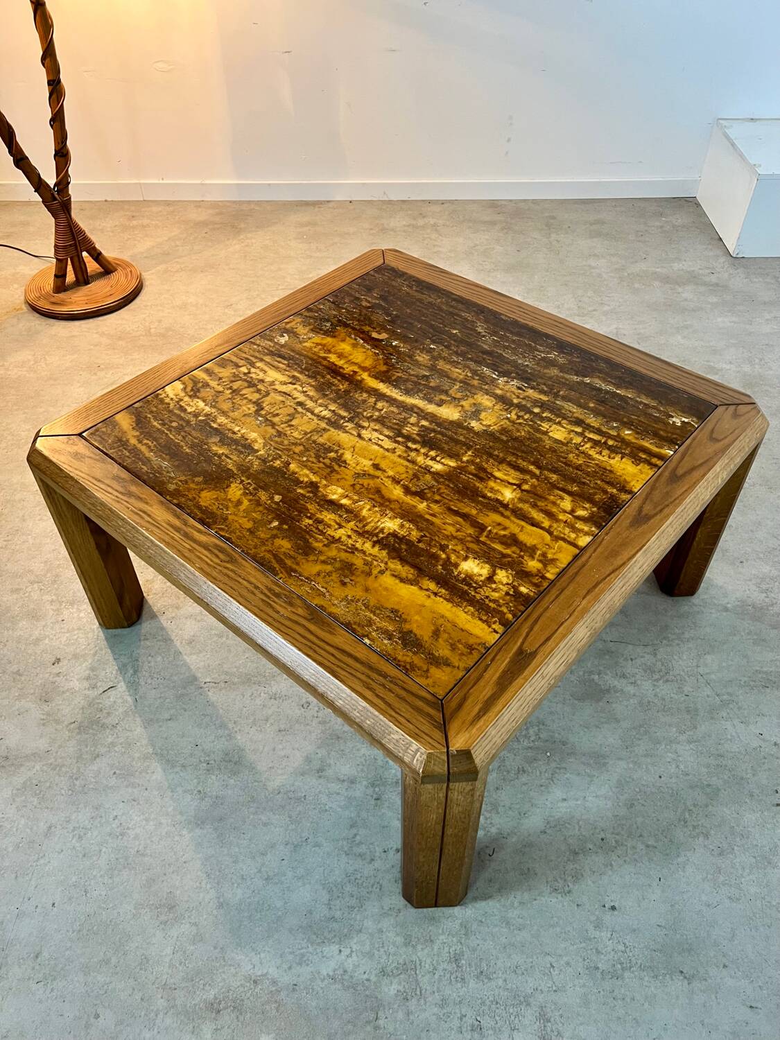Old coffee table with golden marble top, 70s design, vintage wooden feet
