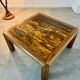 Old coffee table with golden marble top, 70s design, vintage wooden feet