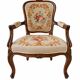 Louis XV style carved wooden armchair with floral needlepoint upholste