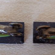 Art Deco pair of bookends with ram's heads, patinated metal and black marble.