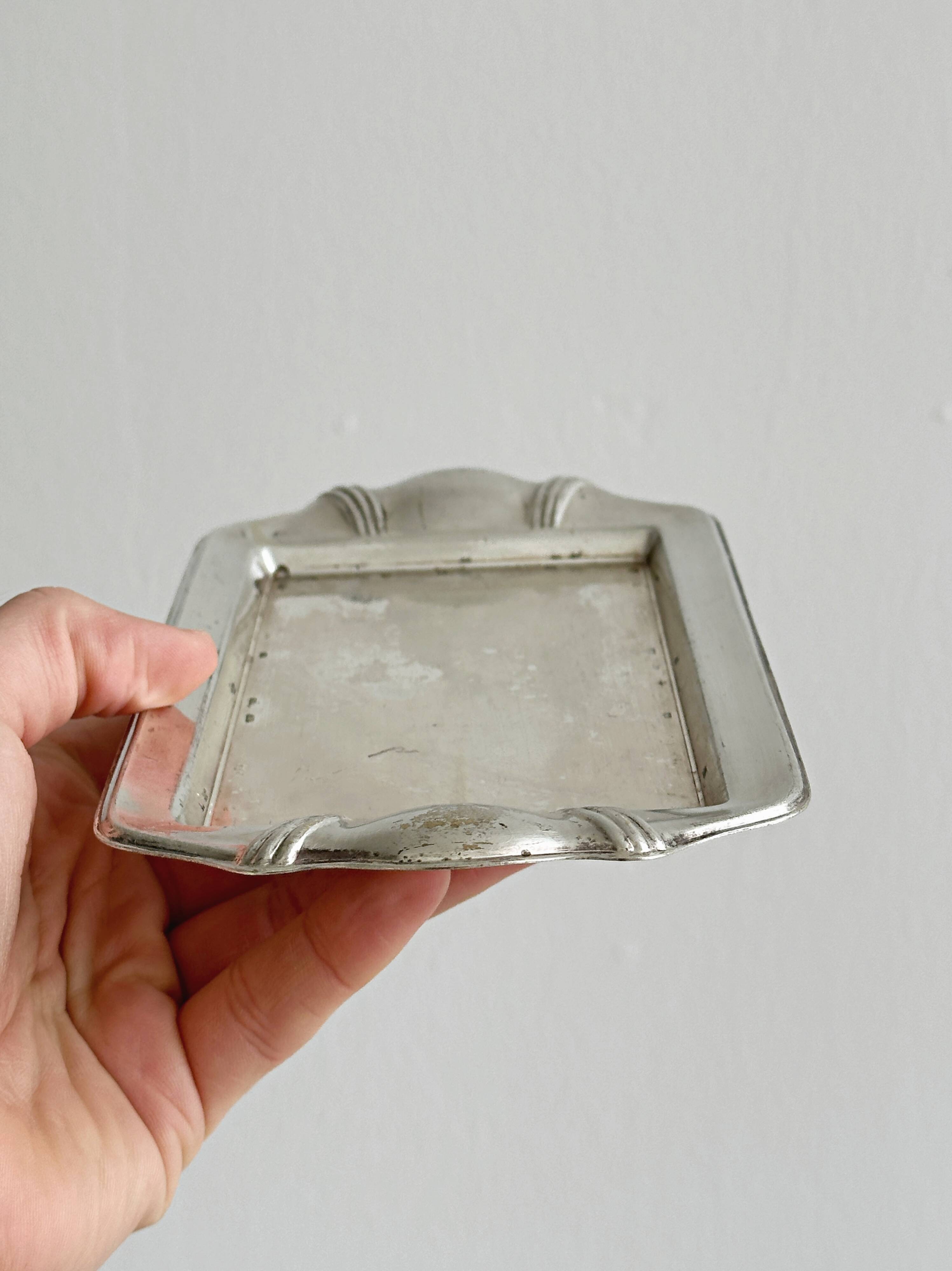 Metal butter dish and thick rectangular glass bowl.