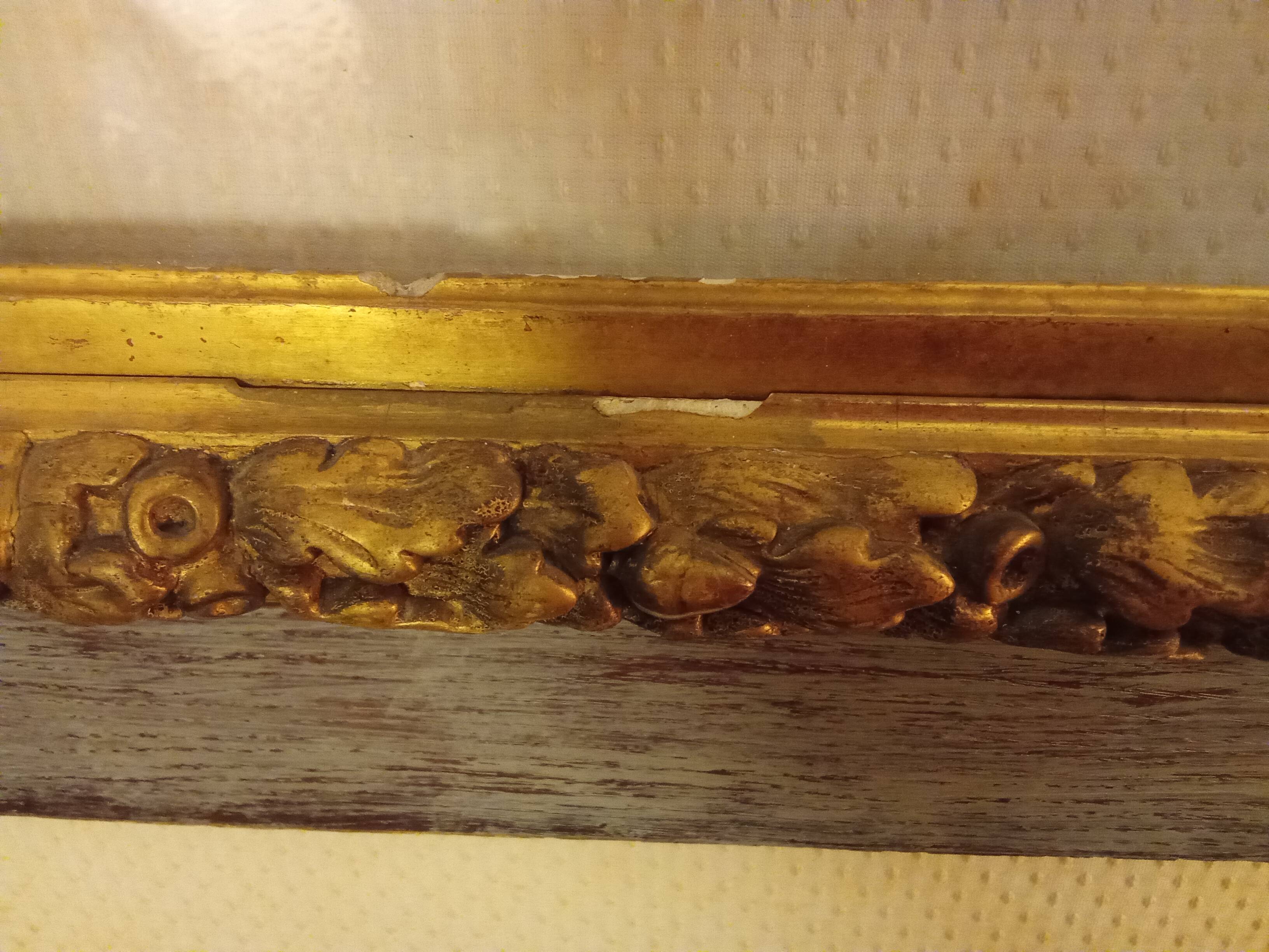 Antique gilded frame with stone lion head ornament on plexiglass