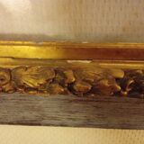 Antique gilded frame with stone lion head ornament on plexiglass