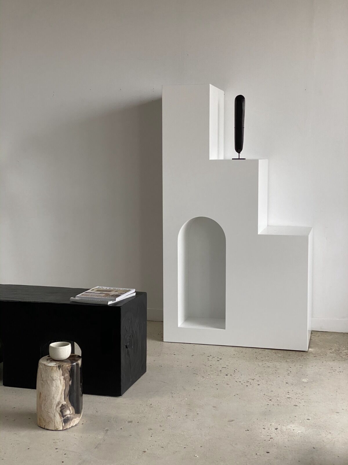 Black solid monoxyl wood bench carved into 3 arches