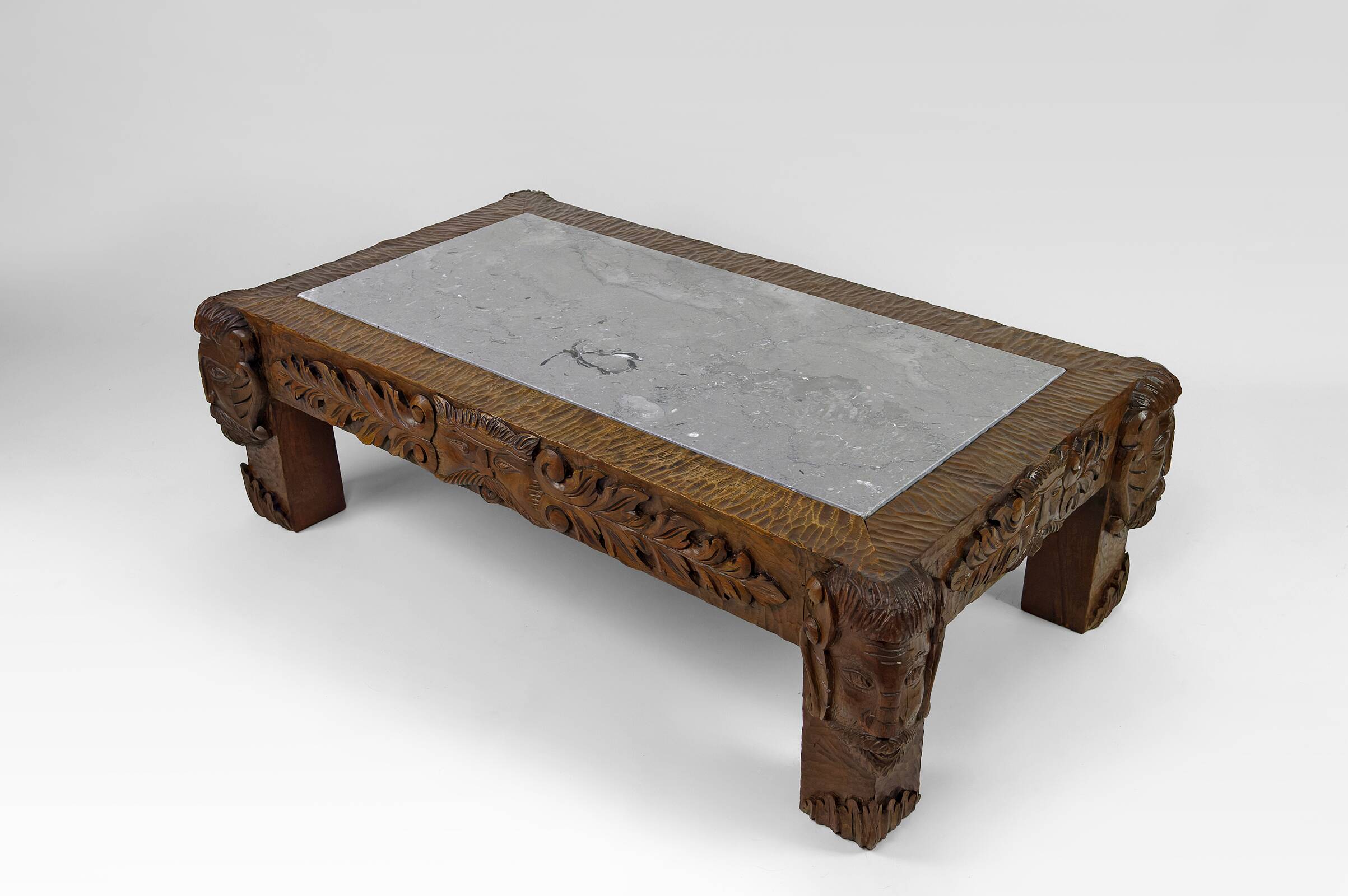 Solid oak coffee table carved with fauns and gray marble top, France, circa 1940