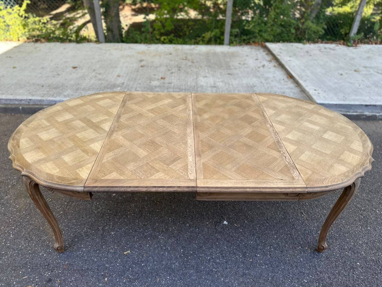 Round extendable dining table Louis XV stripped in solid oak 1950