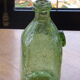 Biot stamped blown glass bottle
