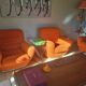 A lot of orange seventies sofas and armchairs.