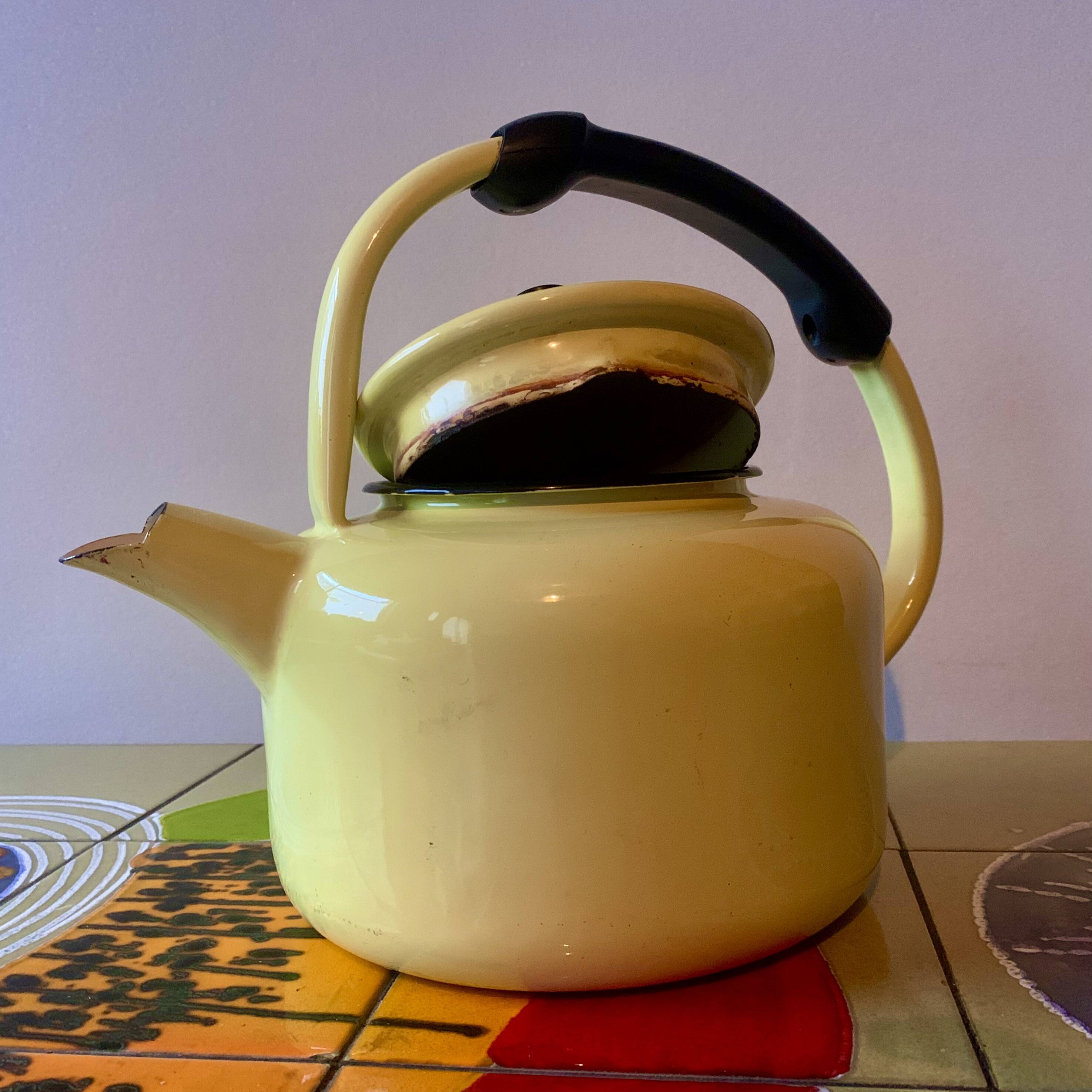Old kettle in yellow enamelled sheet metal and Bakelite