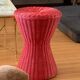 Vintage hourglass stool in red wicker or woven rattan.