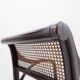 Mid-century curved wooden chairs with cane seats and backs.