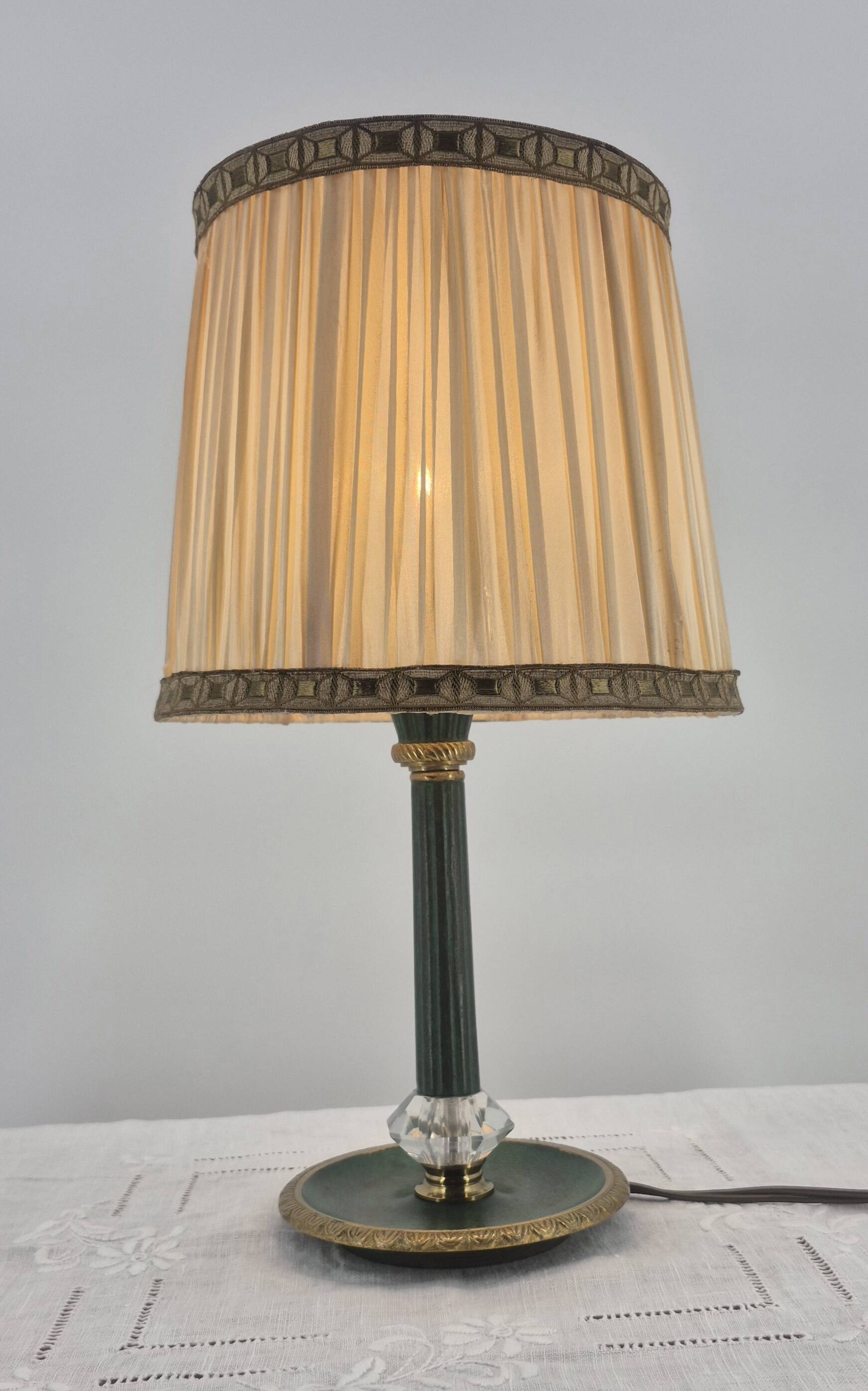 Brass table lamp with green patina and empire-style fabric shade.