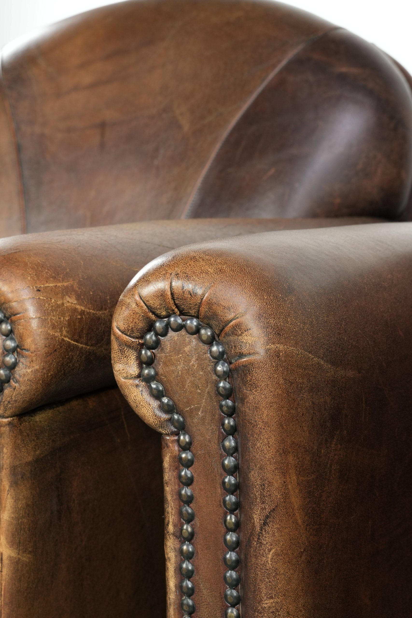 Characterful set of two sheepskin design armchairs with beautiful patina
