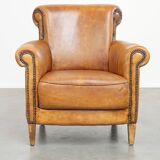 Comfortable, cozy armchair made of sheepskin leather with a proper finish with decorative nailheads