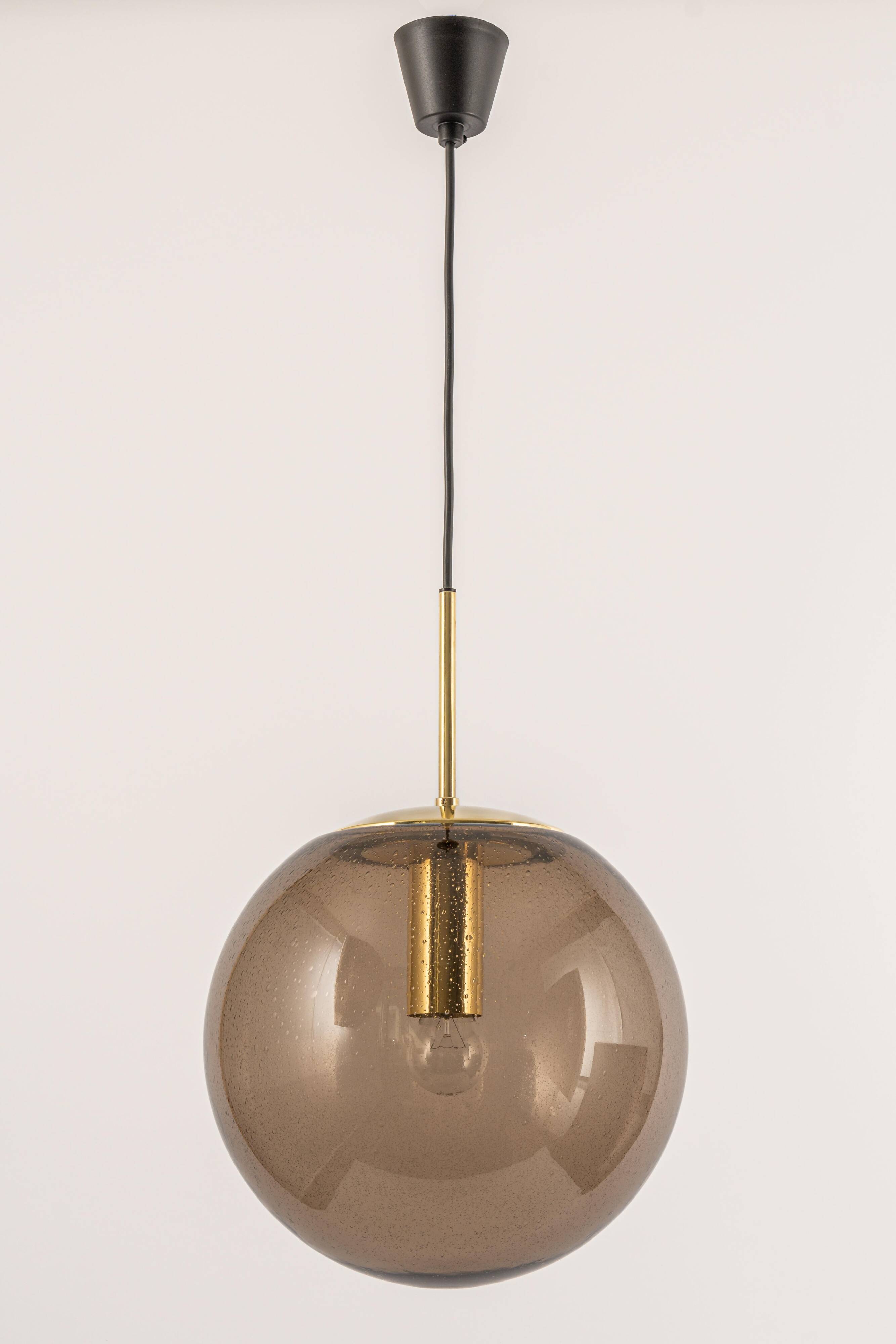Large smoked glass ball pendant by Limburg in brass, Germany, 1970s.